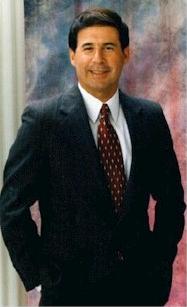 A person in a suit

Description automatically generated with medium confidence